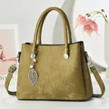Detail of corduroy texture handbag with leaf metal pendant and pearl charm accessory - Grass Green