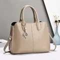 Elegant beige lychee grain leather tote bag with pearl pendant and adjustable strap - Khaki