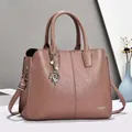 Pinkish purple pebbled leather tote bag with elegant pearl pendant and shoulder strap - Pink