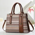 Fashion woven handbag for women with brown leather accents and silver stud detailing - Striped Pattern / Coffee