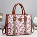 Pink canvas tote bag with cherry print, brown leather trim, and adjustable strap - Pink