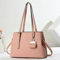 Detail of pink tote bag showing crocodile texture, handles and mini pouch accessory - Pink