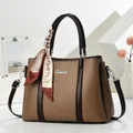 Detail of a brown lychee pattern leather tote bag with printed silk scarf and metal logo - Brown
