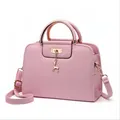 Pink embossed leather handbag with gold deer charm and top handle for women - Pink