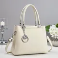 Detail of cream woven leather tote bag with silver ring charm and detachable shoulder strap - Off White