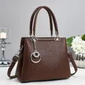 Deep brown leather tote bag with geometric embossed pattern and silver metal hardware - Coffee