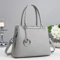Fashionable grey textured tote bag with silver hardware and adjustable shoulder strap - Gray
