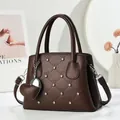 Deep brown quilted leather handbag with rhinestone accents and heart charm detail - Brown