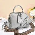 Minimalist light grey leather tote with woven shoulder strap and dual zipper pockets - Pale Fog