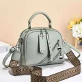 Sage green crossbody bag with textured leather, silver hardware and a wide woven strap - Green