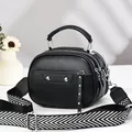 Black pebbled leather crossbody bag with triple zippers and woven strap - Black