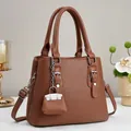 Brown litchi grain tote bag with top handles, adjustable strap and decorative mini charm - 25cmx20cmx11cm / Earthy Yellow