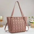 Dusty rose leather tote bag with checkered logo pattern and gold round emblem detail - Pink