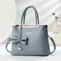 Grey litchi pattern leather handbag with pearl charm and adjustable shoulder strap - Light Blue