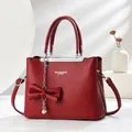 Red lychee texture leather handbag with bow detail and pearl chain decoration - Burgundy