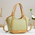 Chic green and camel contrast leather handbag with gold hardware and shoulder strap - Dark Green