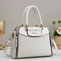 Elegant cream woven leather handbag with gold metal logo and adjustable strap - White