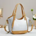 Close-up of silver lychee grain leather tote bag with contrasting brown straps and gold hardware - Silver