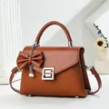 Caramel leather crossbody handbag with bow pendant and elegant silver geometric buckle - 22cmx9cmx16cm (Handle 7cm) / Khaki/Earth Yellow