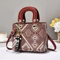 Ethnic woven handbag with red leather handles and adjustable shoulder strap for women - Red
