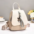 Beige woven texture backpack for women with rabbit pendant in bright indoor setting - Khaki