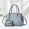 Detail of grey-blue lychee grain leather tote bag with a matching small coin purse attachment - Blue