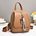 Brown woven leather backpack for women with bunny pendant and stylish letter straps - Earthy Yellow