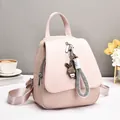 Pink women's fashion backpack with woven texture, top handle, and cute rabbit charm - Pink