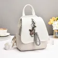 Minimalist cream white woven backpack with stylish rabbit pendant and smooth leather flap - White