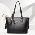 Elegant black lychee leather tote bag with silver triangle plaque and silk scarf handle - Black