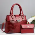 Dark red tote bag set with crocodile texture, gold ring lock, and matching clutch bag - Two-Piece Set / Red