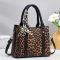 Detail of leopard print handbag featuring black leather trim and elegant silk scarf accent - Length 26 cm, Width 11.5 cm, Height 21 cm, Handle 14 cm / Earthy Yellow