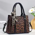 Chic leopard print trapeze handbag with silk scarf handle and adjustable shoulder strap - Length 26 cm, Width 11.5 cm, Height 21 cm, Handle 14 cm / Coffee