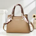 Elegant brown lychee leather handbag for women with decorative silk scarf and shoulder strap - Khaki