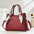 Elegant burgundy pebble leather handbag for women featuring a decorative silk scarf - Burgundy