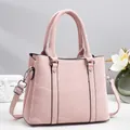 Pink textured handbag with double handles and adjustable strap for commuting - Pink