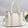 Detail view of cream handbag showing marbled synthetic leather and silver metal buckles - Off White