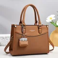 Elegant dark brown tote bag with woven texture, silver hardware and a mini charm - Earthy Yellow