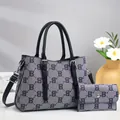 Detail of grey monogram tote bag set with matching long wallet and silver hardware - Blue with Black