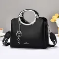 Black lychee leather handbag with silver round handle and heart padlock detail - Black