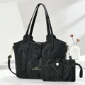Black crinkle texture tote bag set with golden logo lettering on elegant white background - Black
