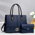 Minimalist navy blue tote bag set with brown handles and gold hardware details - Blue
