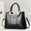 Elegante schwarze Handtasche mit Krokodilmuster, Silbergriffen und verstellbarem Riemen - Schwarz