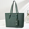 Detail of dark green woven tote bag with a small matching purse and gold hardware - Green