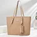 Close-up of beige woven tote bag with refined gold buckles and matching small pouch - Light Khaki