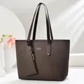 Close-up of deep brown tote bag with woven texture and matching zipper pouch - Coffee