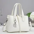Elegant white faux leather crossbody handbag with minimalist HD metal pendant and slim handles - Off-White (A96254)
