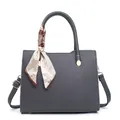Dark grey pebble leather crossbody handbag with decorative silk scarf on white background - Gray