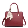 Elegant burgundy leather top-handle bag with striped scarf detail and shoulder strap - Red