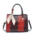 Detailed close-up of dark red gradient faux-crocodile leather tote bag with silk scarf - Red